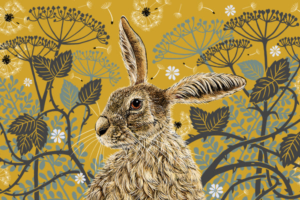 This tea towel design features a hare portrait with one floppy ear, around the hare are stylised brambles, leaves, cow parsley and dandelion puffs, background colour is a mustard yellow.