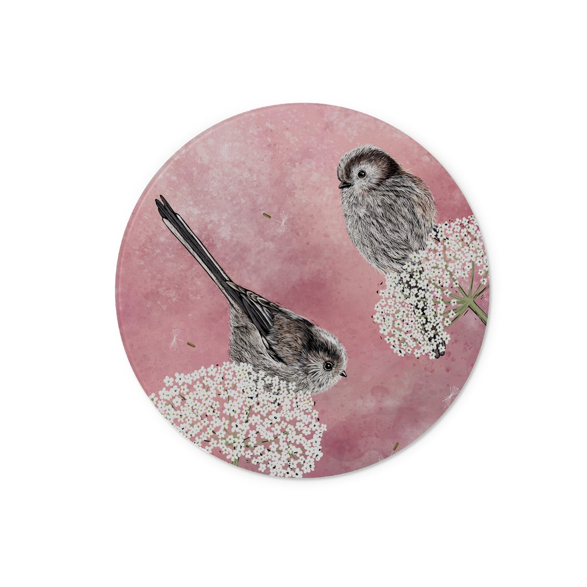 This glass chopping board design from Fox and Boo depicts two cute long tailed tits balancing on some cow parsley, background is a watercolour berry pink, with floating dandelion puffs.