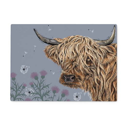 This design features a portrait of a highland cow, surrounded by thistles and dandelion puffs, on a dusk grey background.